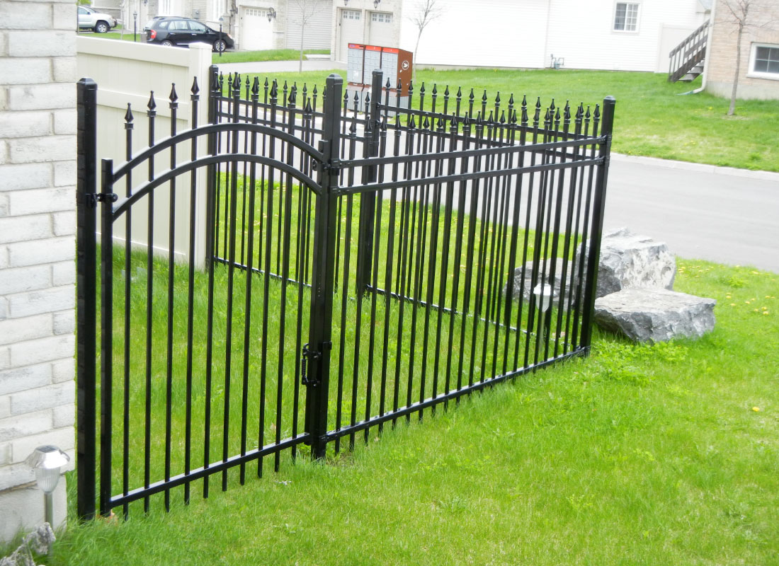 Iron Fence & Stone Piers installed in Rockcliffe Park, Ontario by Fence Masters Ottawa — Iron panels set between masonry piers for a formal front-yard perimeter