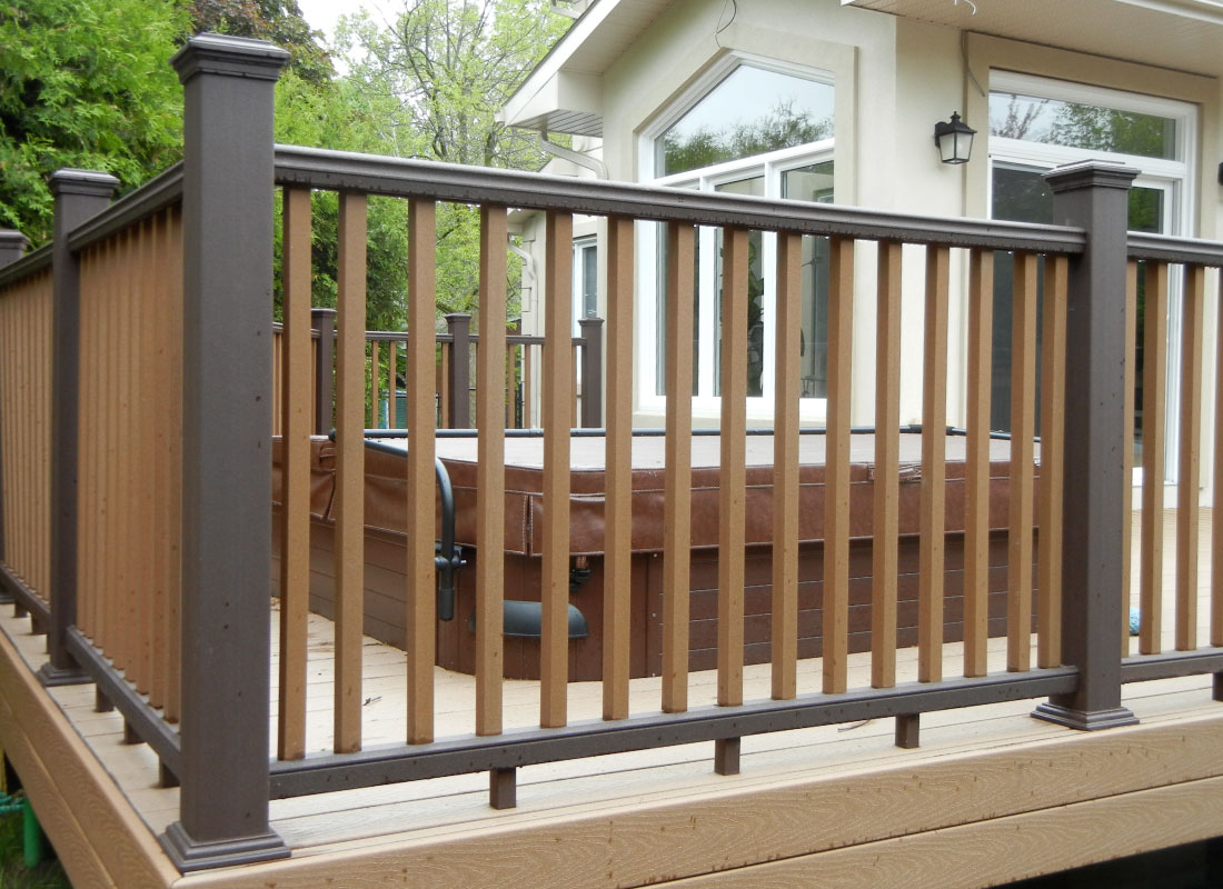 Aluminum Deck Railing installed in Kanata, Ontario by Fence Masters Ottawa — Slim black aluminum picket railing wrapping a raised rear deck
